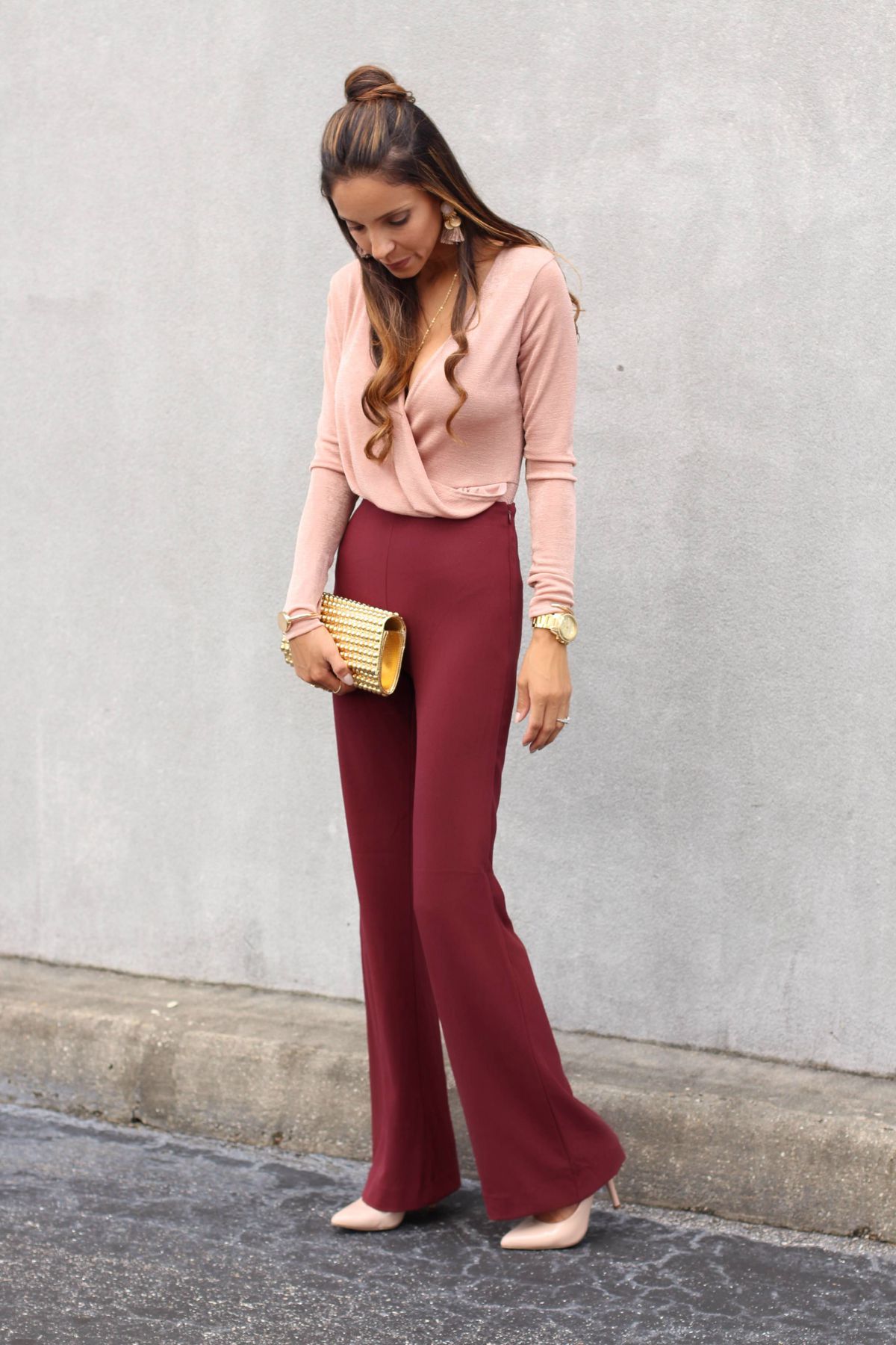 blush bodysuit paired with burgundy high-waist pants