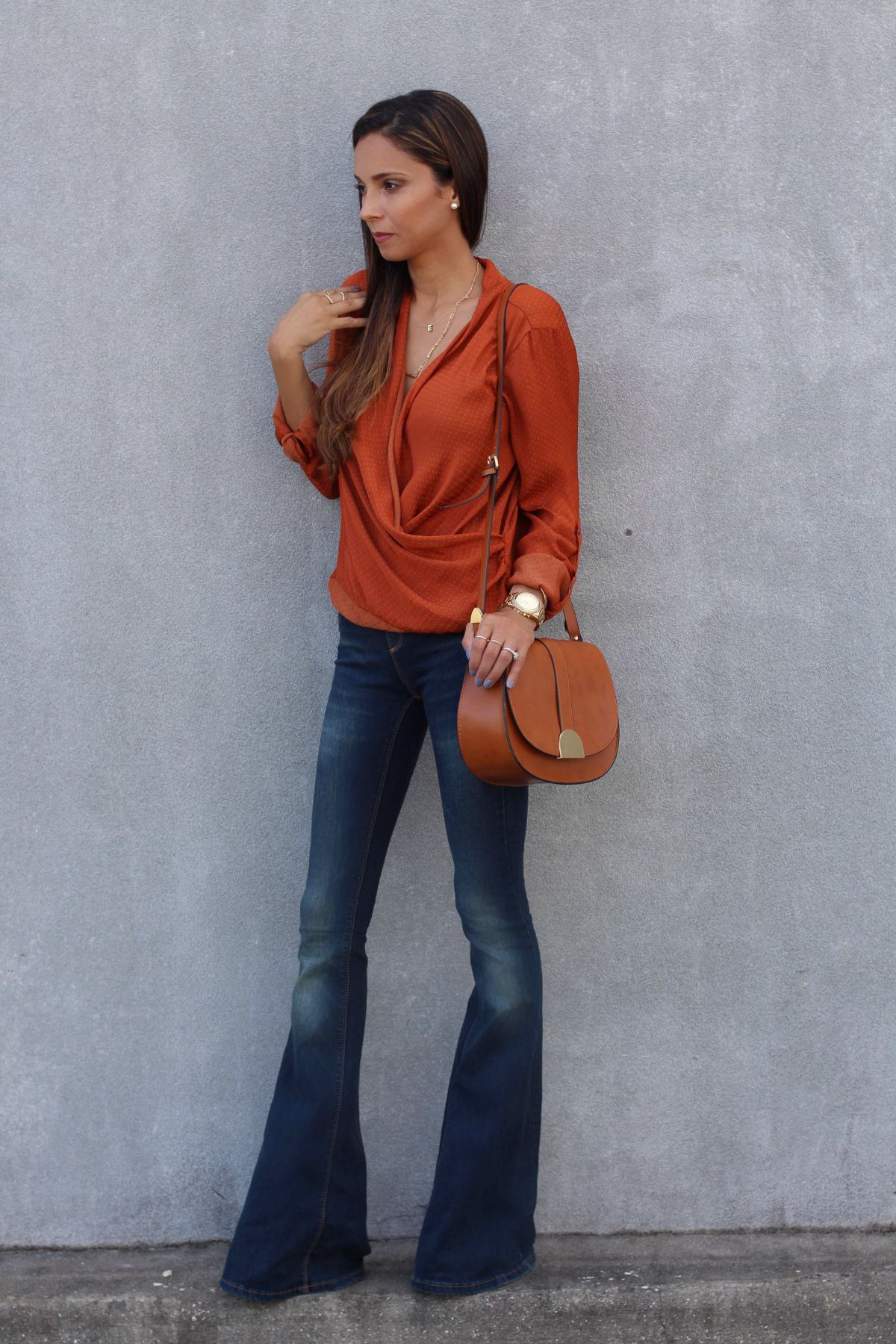 Free People stretchy flare jeans, a rust wrap blouse and wedges
