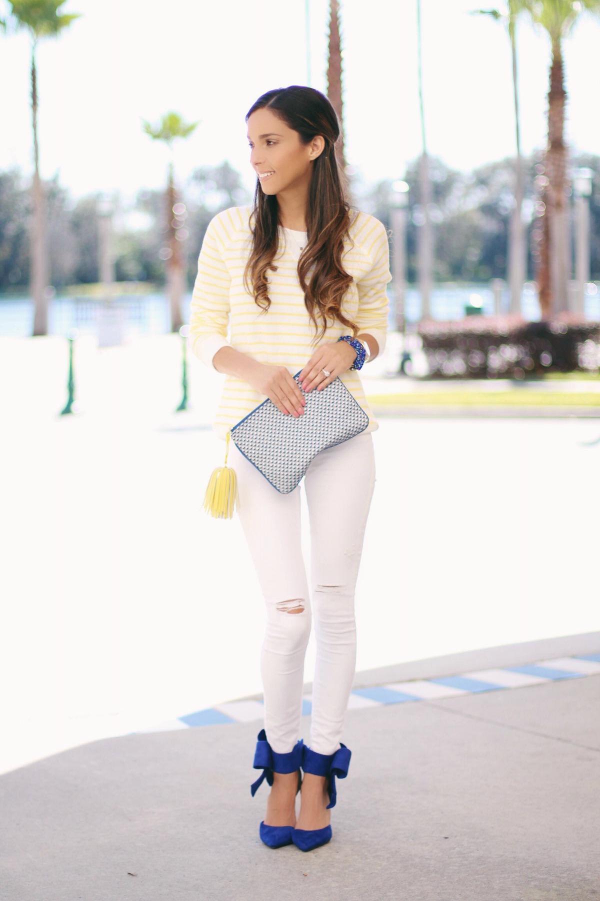 Yellow and White Stripe Sweatshirt with white ripped jeans and blue bow heels