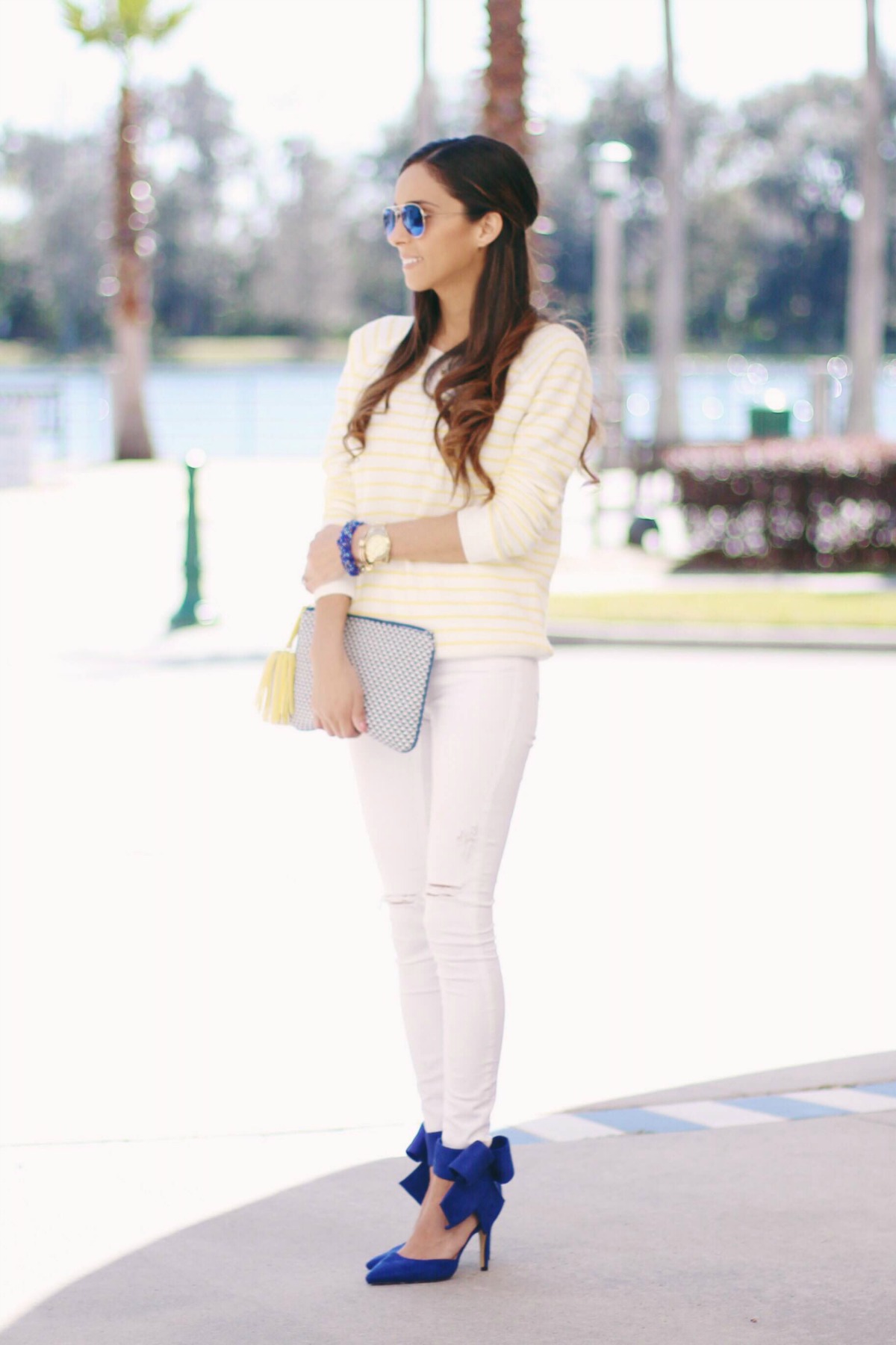 Yellow and White Stripe Sweatshirt with white ripped jeans and blue bow heels