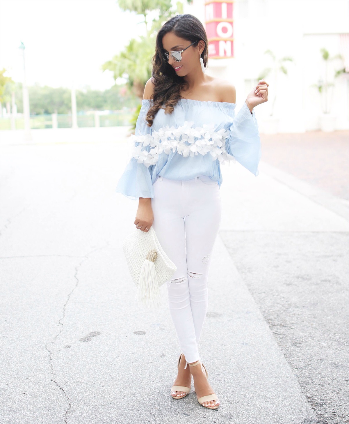 Light blue off the shoulder top with trimmed flower detail and white jeans