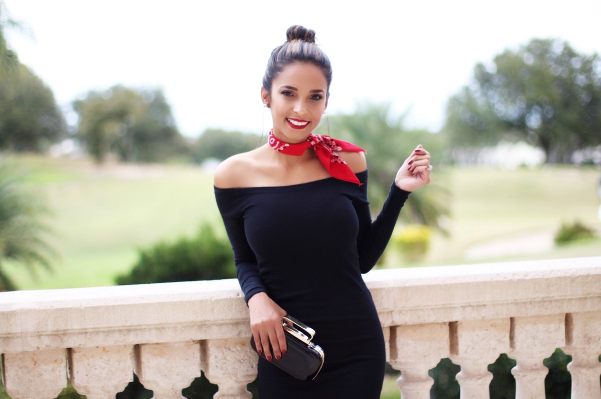 Off the shoulder little black dress with red bandanna and black clutch